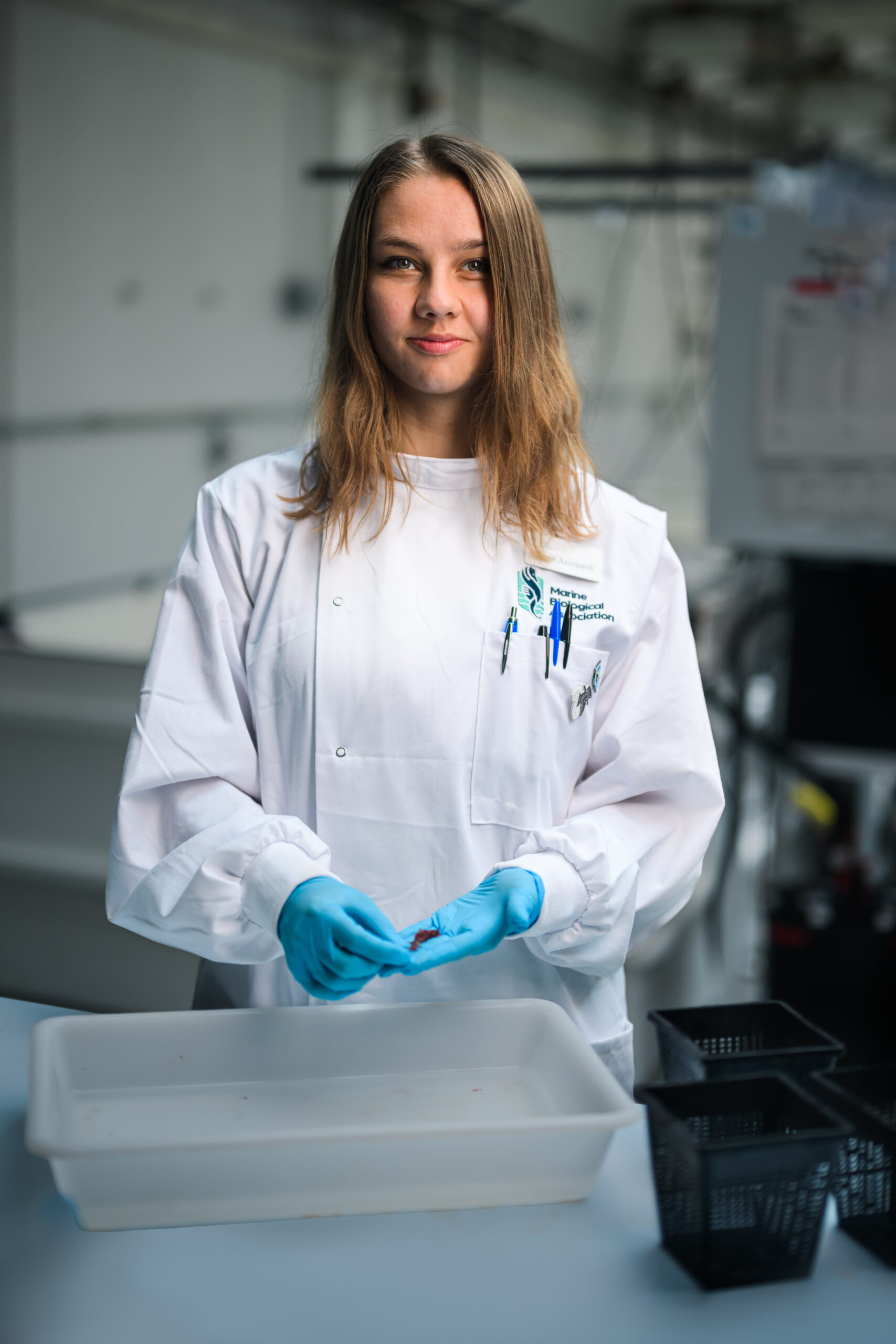 Freja Azzopardi standing in labcoat with specimen