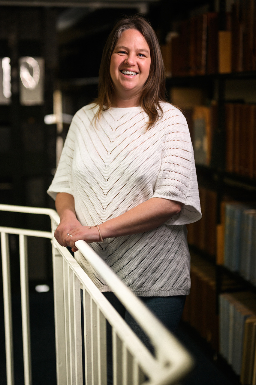 Julie Bunt smiling standing in front of MBA library