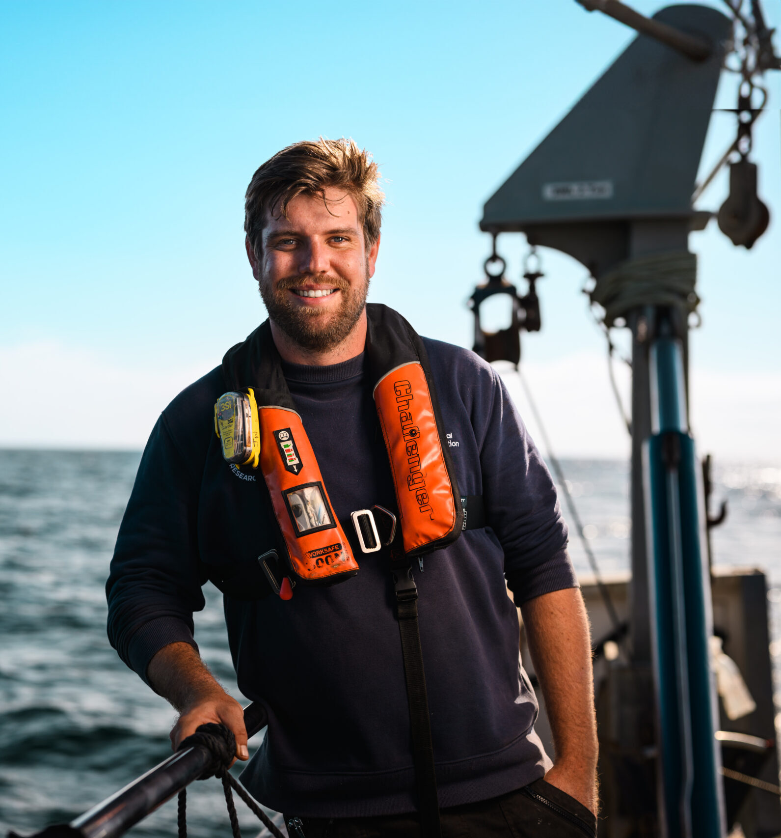 James Whicheloe leaning against the gunwhale of Research Vessel Sepia