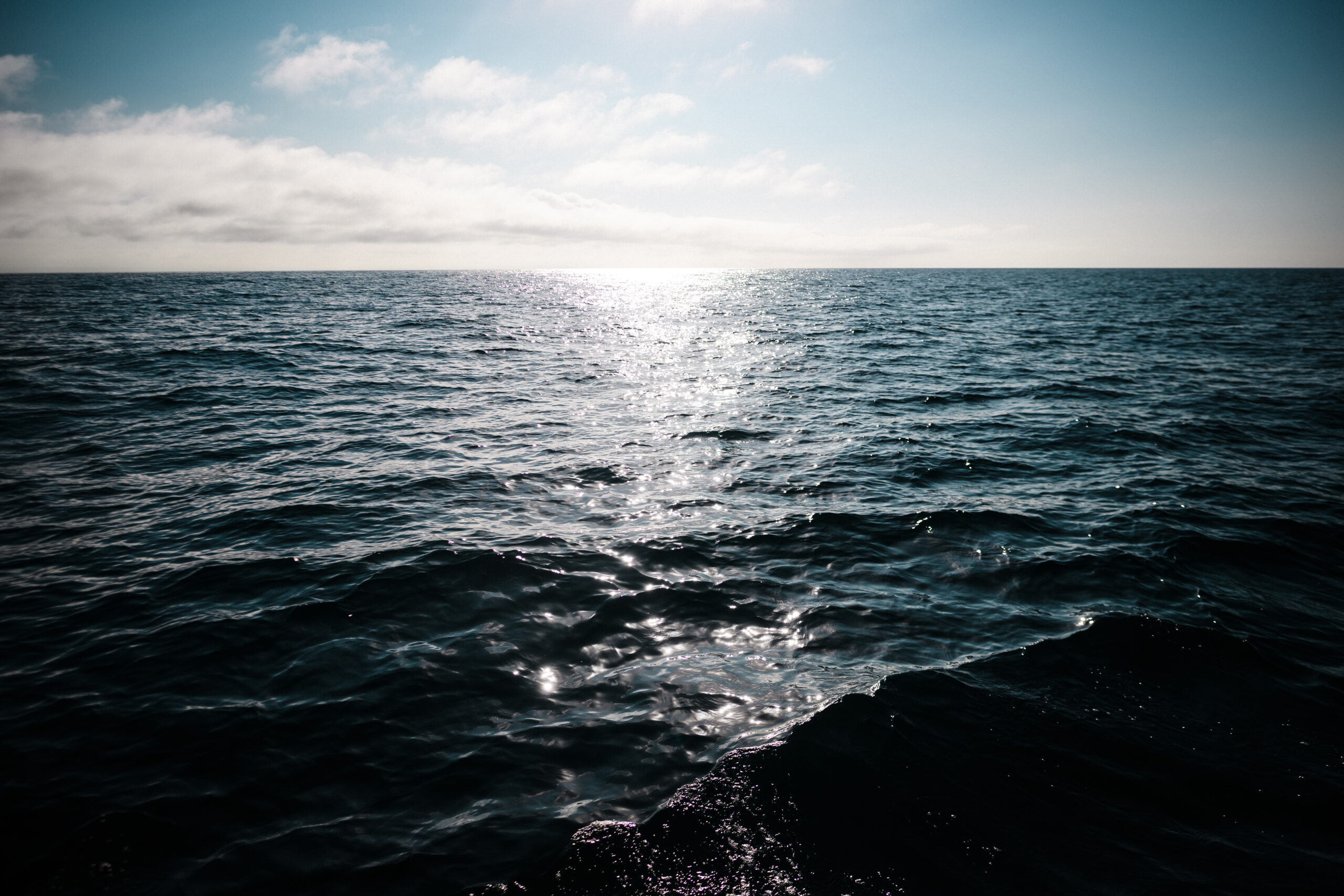 Sepia sea view of the ocean with the sun shining.