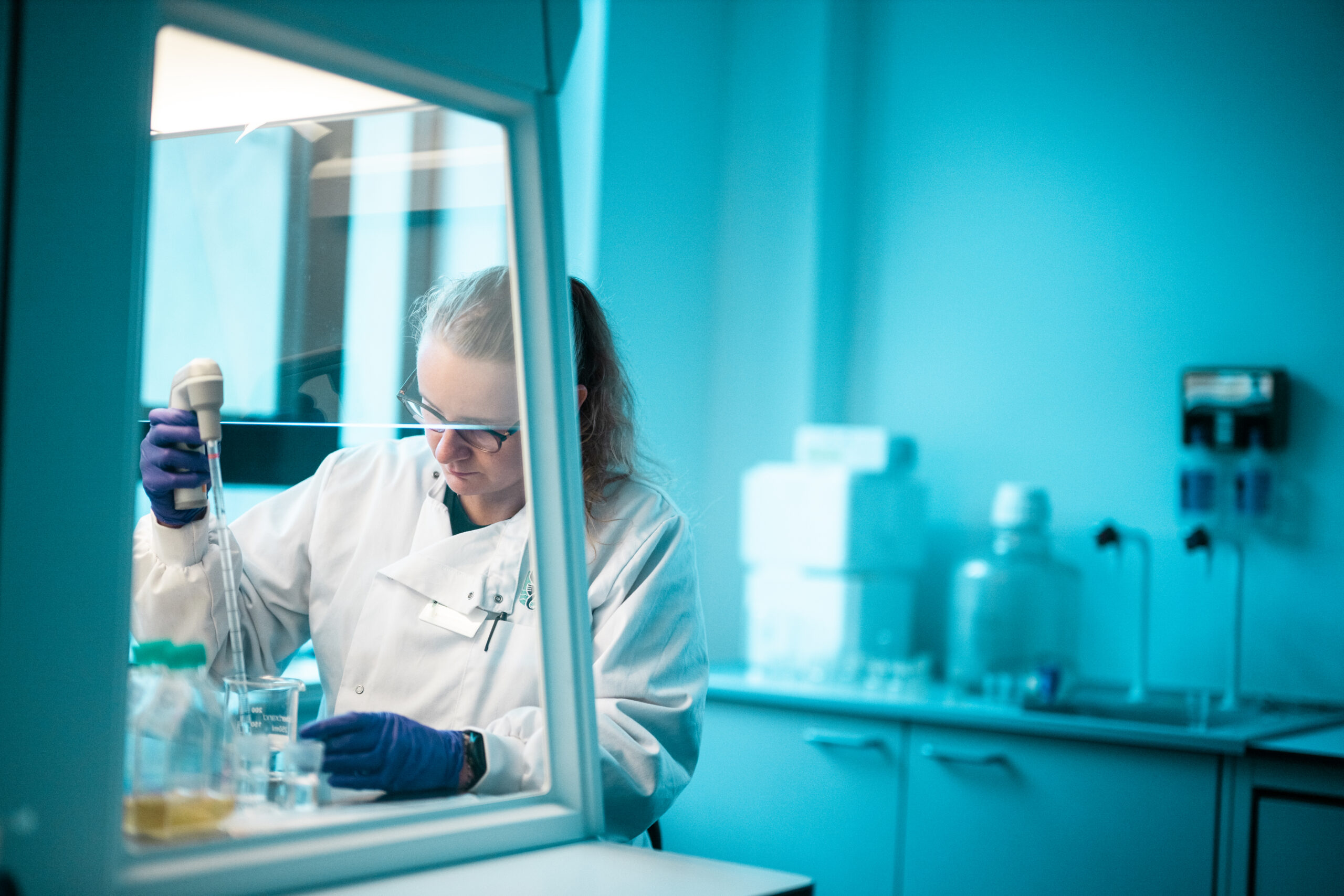 researcher using a pipette in the microbiome lab